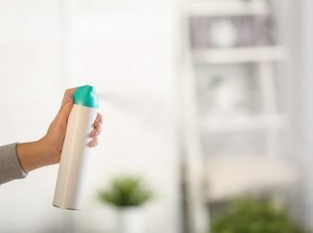 Woman,Spraying,Air,Freshener,At,Home Woman,Spraying,Air,Freshener,At,Home